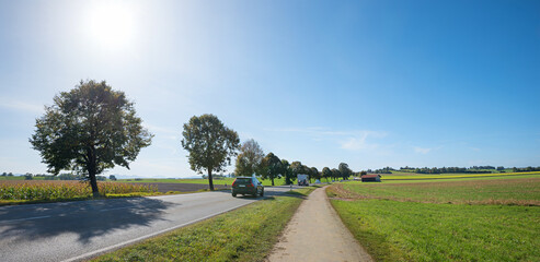 traffic at country road to Bad Tolz Sachsenkam, rural landscape upper bavaria