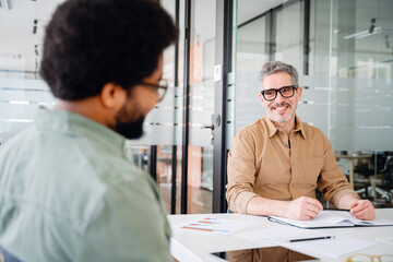 The diverse team during the meeting. Two professionals engage in a productive brainstorming session...