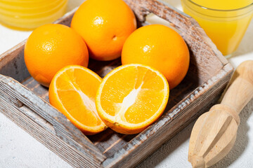 fresh oranges on a wooden tray, top view
