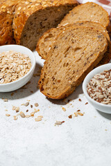 healthy bread with oats and seeds on white background, vertical