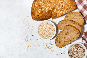 healthy bread with oats and seeds on white background, top view