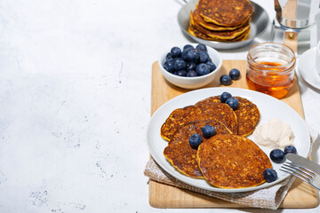 homemade pancakes with blueberries and yogurt on white background