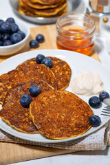 homemade pancakes with blueberries and yogurt, vertical closeup