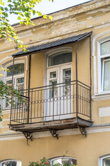 balcony with decorative elements on an old brick building