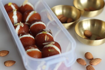 Malai Gulab Jamun. Gulab Jamun sandwich with milk cream filling. Fusion of Indian sweet dessert, golden brown, soft, and soaked in sugar syrup