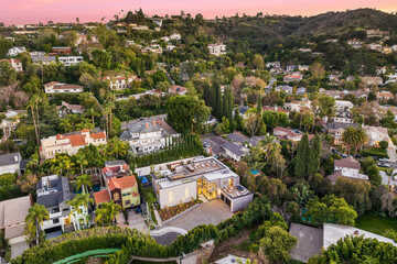 Fototapeta na wymiar Aerial shot of houses and hills at sunset
