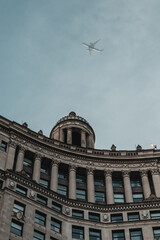 Obraz premium building with plane overhead