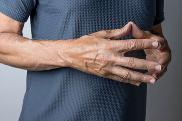 Man holding his hands folded in front of him   