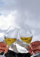 Toast concept: cheers, cincin, with two glasses of Prosecco white wine, the highest aperitif in...