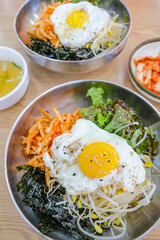 Bibimbap, a traditional Korean food, is a bowl of rice mixed with assorted vegetables and egg. South Korea