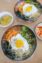 Bibimbap, a traditional Korean food, is a bowl of rice mixed with assorted vegetables and egg. South Korea