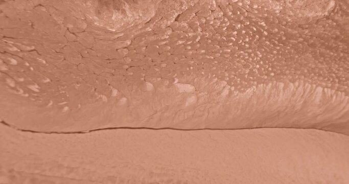 4k footage of Peach Fuzz fluid slow flow background. Beige ink abstract in motion close-up. Dynamic nude art of fluid paints. Flowing texture. Watercolor liquid abstraction. Peach color video backdrop
