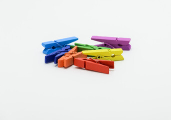 multicolored clothespins on a light background
