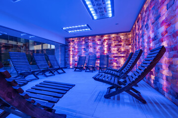 interior of modern wellness salt haloper cave with uv light with wooden bench