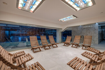 interior of modern wellness salt haloper cave with uv light with wooden bench