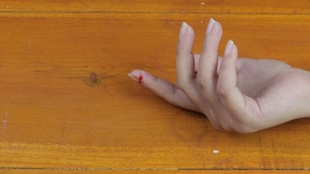 First aid for a hand bleeding from a knife with a bandage