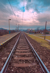 Obraz premium Parallel railroad tracks at a small train station in eastern Slovakia