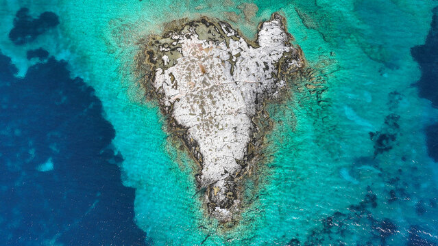 Aerial drone photo of secluded heart shaped island with turquoise sea in Caribbean exotic destination