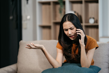 Fototapeta premium Woman talking on the phone arguing laptop computer problems highlighting customer dissatisfaction.