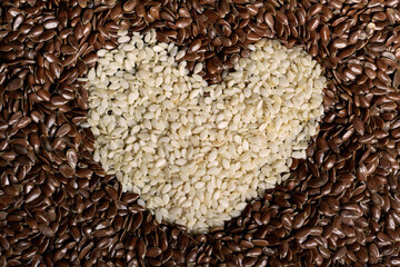 heart of sesame on flax-seeds background