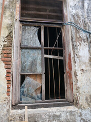 a broken window of abandoned building. surabaya, indonesia - 4 january 2024