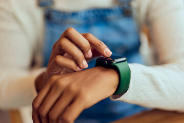 Obraz na płótnie Canvas Close-up of a female using her wireless smartwatch.