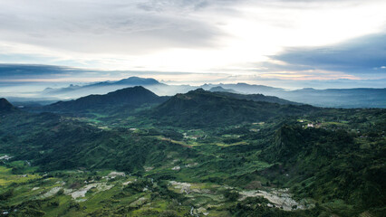 Fototapeta premium panorama of beautiful countryside of bogor. sunny morning. wonderful springtime landscape in mountains. grassy field and rolling hills. rural scenery. 