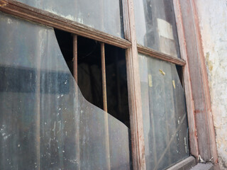 a broken window of abandoned building. surabaya, indonesia - 4 january 2024