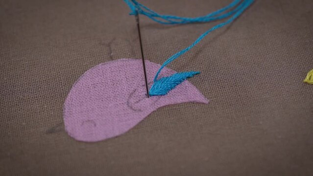 Crafting Beauty: Stitching Art of Bird with Pink and Blue Floss Threads