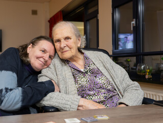 Elderly mother and daughter together on a visit to a nursing home