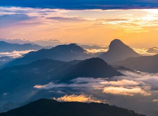 Aerial view of misty mountains at sunset