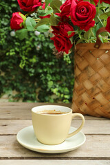 Cup of Coffee with a Basket of Roses in the Backdrop