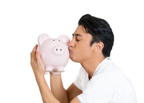 young man giving a kiss to a piggy bank