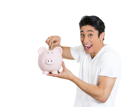 Excited young man with a piggy bank
