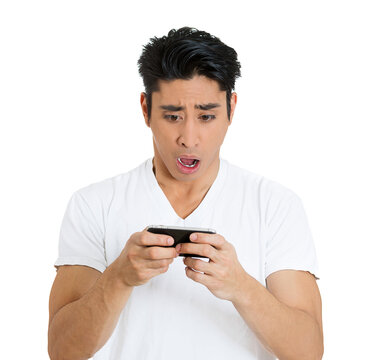 Portrait of a young shocked man watching news on his mobile phone