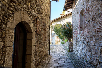  Among old stone houses a narrow road leads to an ancient monastery on Lake Maggiore