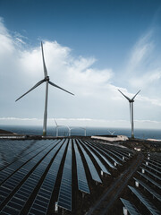 windmill and solar panel farm producing renewable energy with wind and sun © goami