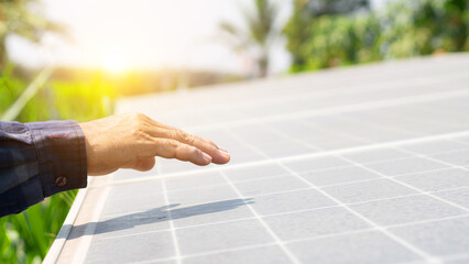 Close up of an young engineer hand is checking an operation of sun and cleanliness of photovoltaic...