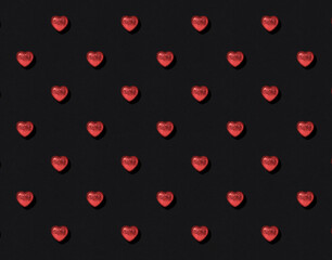 Pattern of red shiny hearts on black background. Valentine's Day card