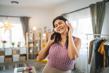 One woman with headphones at home listen music online happy smile sing