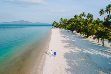 Koh Mook Drone view at a couple walking on the white sandy tropical beach of Koh MukThailand