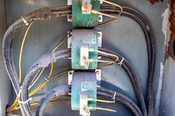 Closeup of dirty black cables of switches and circuit in control box, system and electrical...