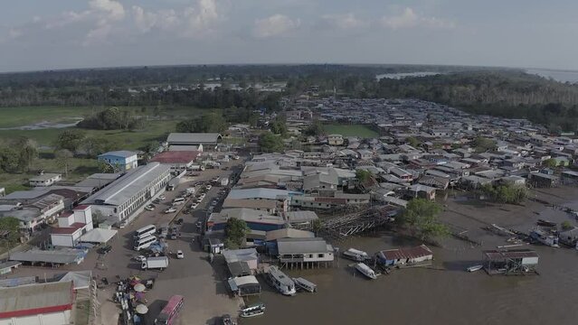 The city of Careiro da Varzea lies on the banks of the Solim&otilde;es River, near the capital Manaus, in the Brazilian Amazon. Aerial view on a sunny day with late evening light.