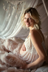 Fototapeta premium Pregnancy Bliss:A young blonde pregnant woman in the bedroom in summer