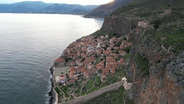 Europe,Greece , Laconia - Monemvasia is a  tied island tourist attraction summer destination in  east coast of the Peloponnese - drone arial view of fortified city with walls by the sea
