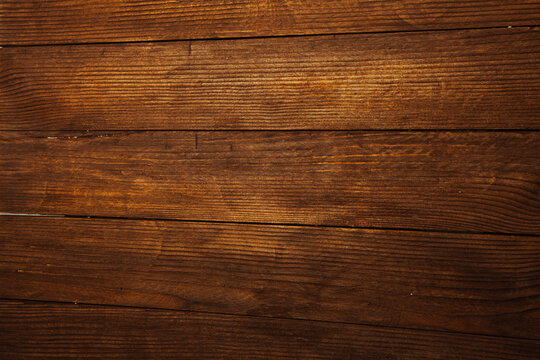 Vintage brown wood background texture with knots and nail holes. Old painted wood wall. Brown abstract background. Vintage wooden dark horizontal boards. Front view with copy space