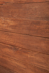 Vintage brown wood background texture with knots and nail holes. Old painted wood wall. Brown abstract background. Vintage wooden dark horizontal boards. Front view with copy space