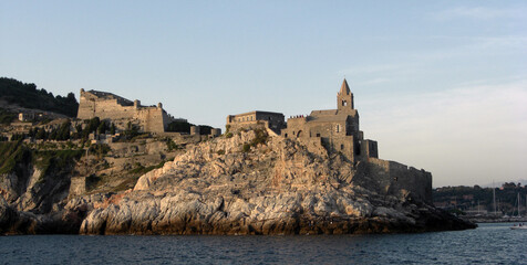 Landscape of Portovenere with the Doria castle and the church of San Pietro as seen from the sea. Porto Venere, La Spezia, Italy