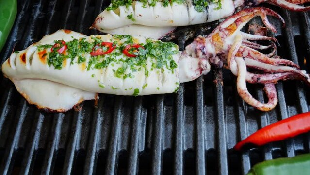 Squids on the cast iron grill barbecue. Seafood.  Squids on grill
