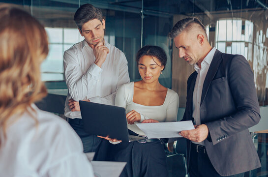 Group of people discussing daily plans in the office using laptop. Business teamwork situation 